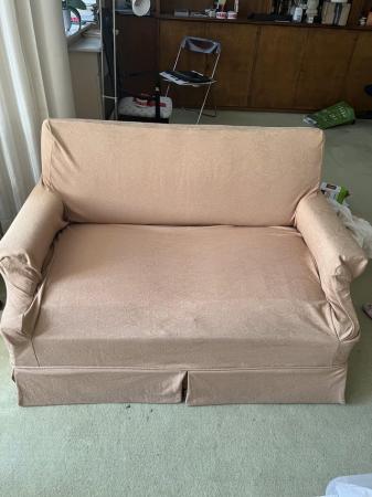 Image 1 of A two seater sofa bed upholstered