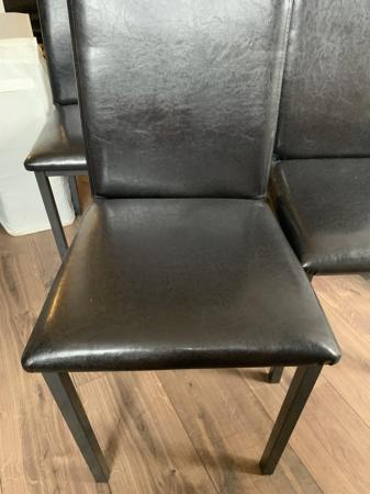 Image 1 of Four black faux leather dining chairs
