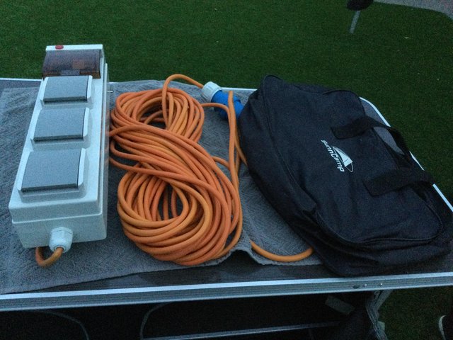 Preview of the first image of camping electric hookup and bag.