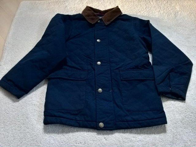 Preview of the first image of Osh Kosh boy's navy quilted coat age 10.