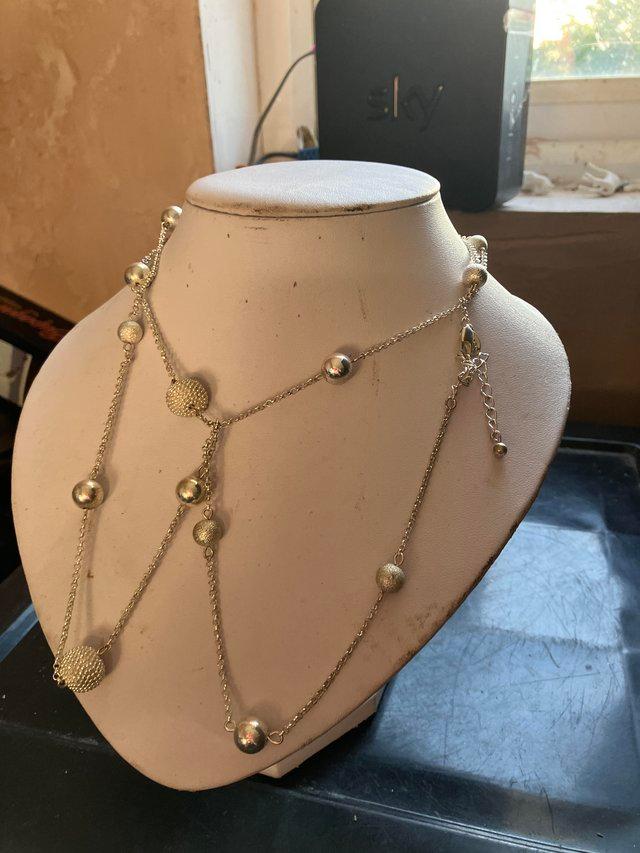 Preview of the first image of Long white metal and crystal necklace.