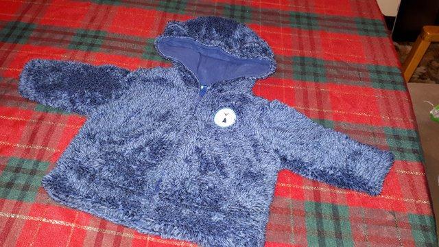 Preview of the first image of Little Rocha fluffy blue coat aged 0-3 months.