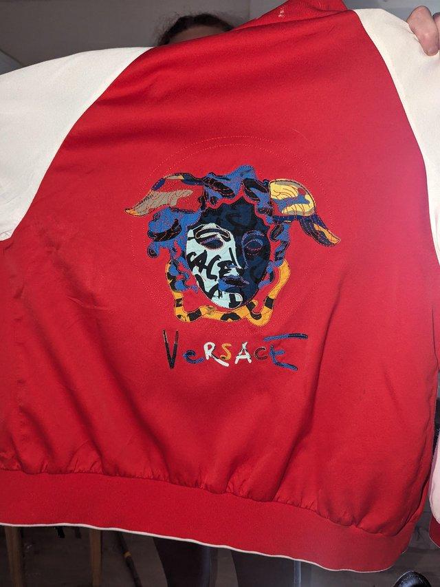Preview of the first image of Versace jacket red and white zip up.
