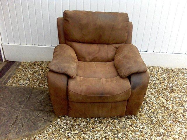 Preview of the first image of A brown coloured reclining chair.