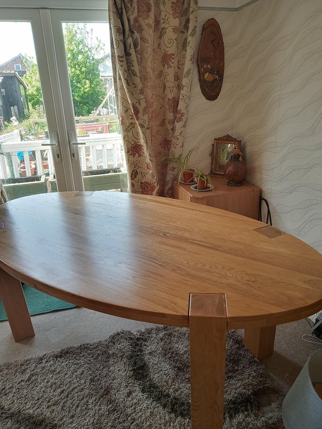 Preview of the first image of Large oval solid oak dining table.