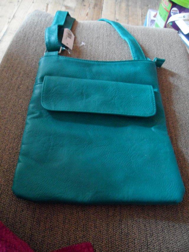 Preview of the first image of New ladies teal coloured handbag.