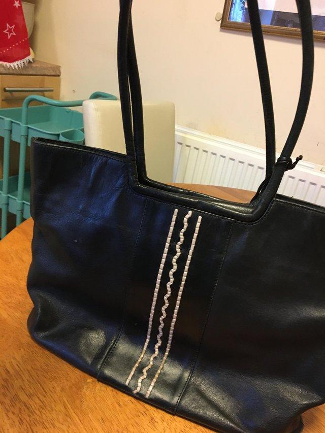 Preview of the first image of Vintage Radley black leather handbag.