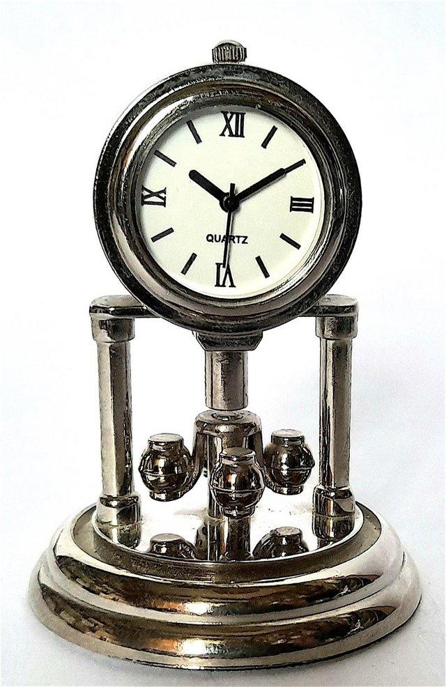 Preview of the first image of MINIATURE NOVELTY CLOCK - TURNING MANTLE.