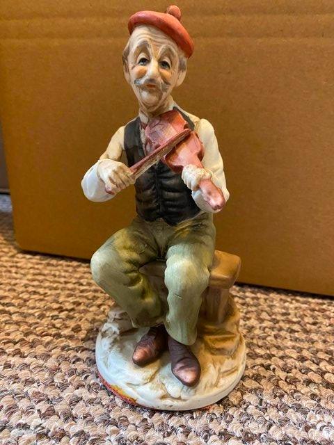 Preview of the first image of Vintage CapoDiMonte Figure of Old man playing violin.