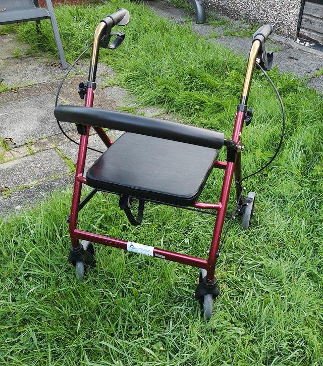 Preview of the first image of 4 wheeled rollator with seat and brakes.