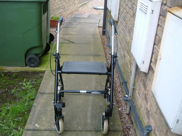 Preview of the first image of disability walker good condition with seat and it folds up f.