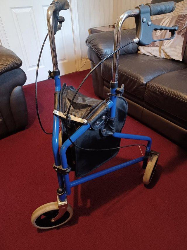 Preview of the first image of 3 wheel walker with bag good condition.