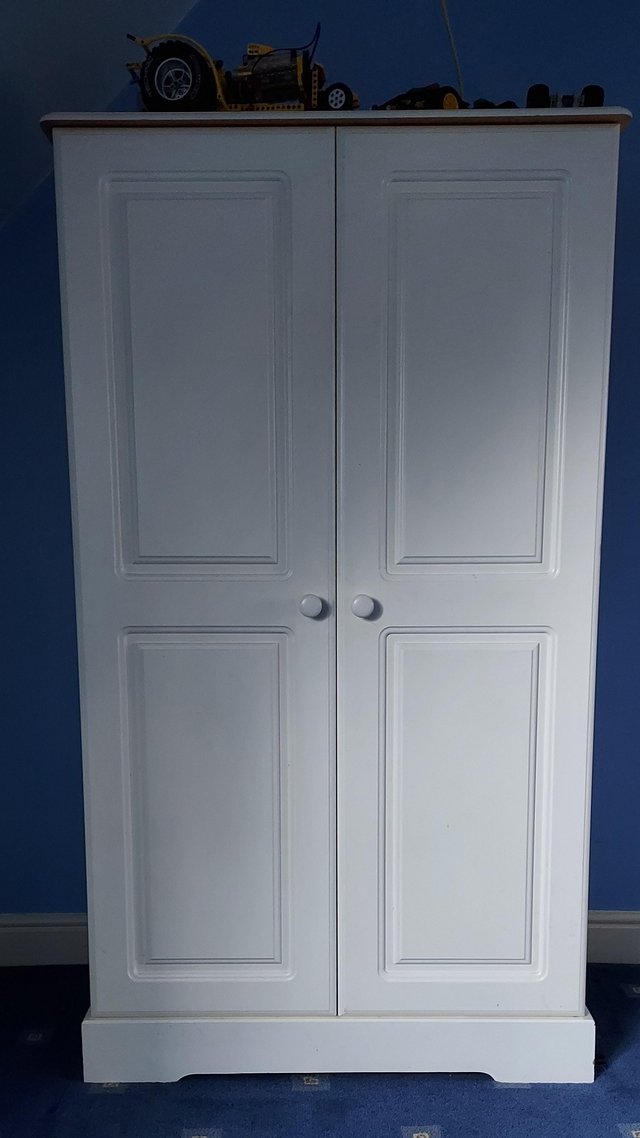 Preview of the first image of White Nursery Wardrobe with rails and shelves.