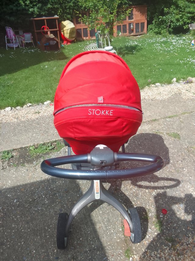 Preview of the first image of STOKKE push chair in red.