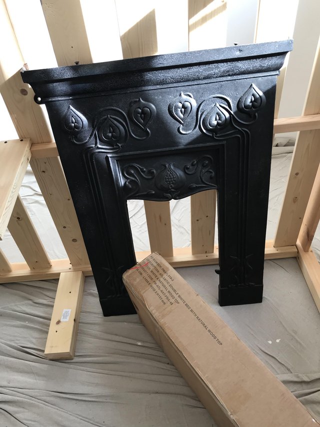 Preview of the first image of Black cast iron bedroom fireplace.