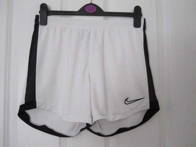 Preview of the first image of Girls Nike Dri-fit shorts in white.