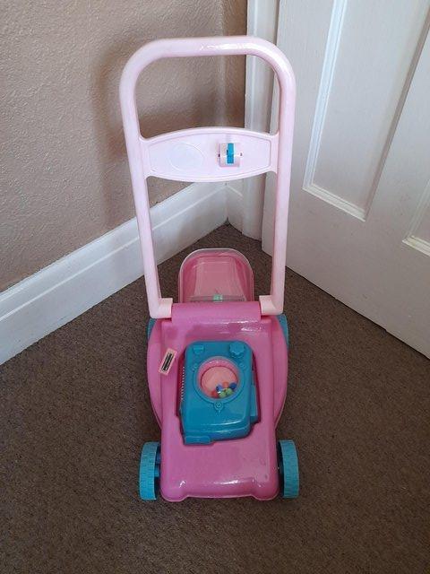 Preview of the first image of Kids pink push a long toy lawnmower.