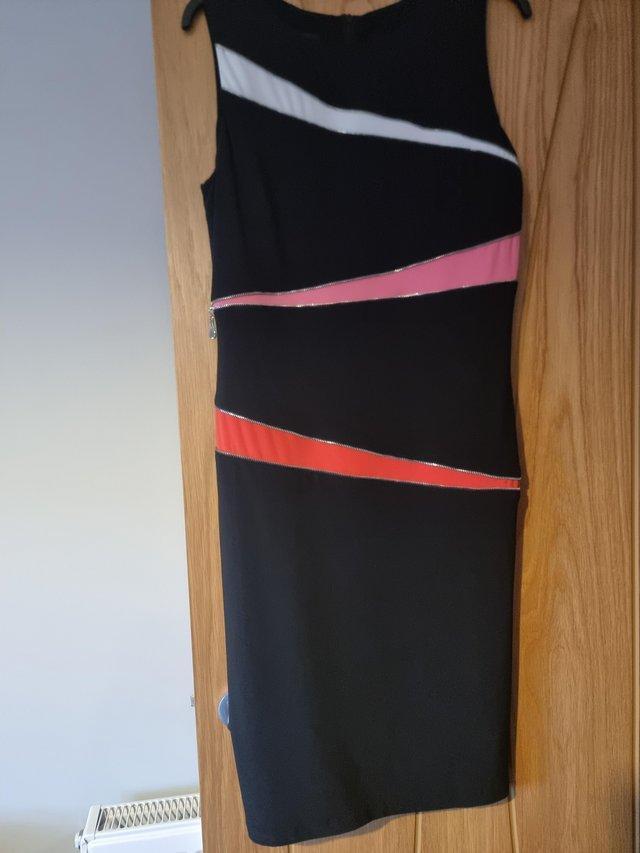 Preview of the first image of Tia Black Dress with orange/white with zip detail. Size 16..