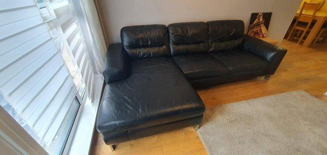 Preview of the first image of DFS L shaped black leather sofa in good condition.