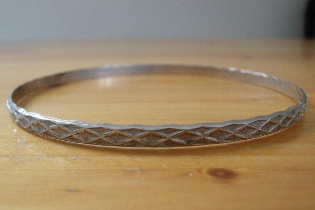 Image 3 of 3 bangles:2 silver colour;1 brown/gold colour.