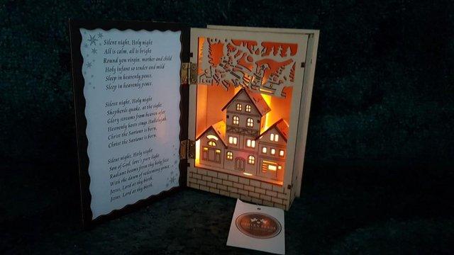 Preview of the first image of Beautiful wooden book ornament - Lights up and plays music -.