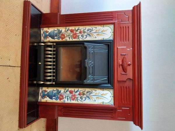 Image 1 of Mahogany fireplace with ceramic tiles and electric fire