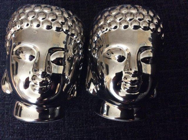 Preview of the first image of 2 small chrome Buddha tea light candle holders.
