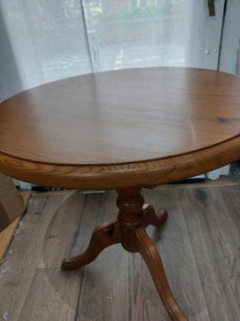 Image 1 of Small round  pine occasional/coffee table