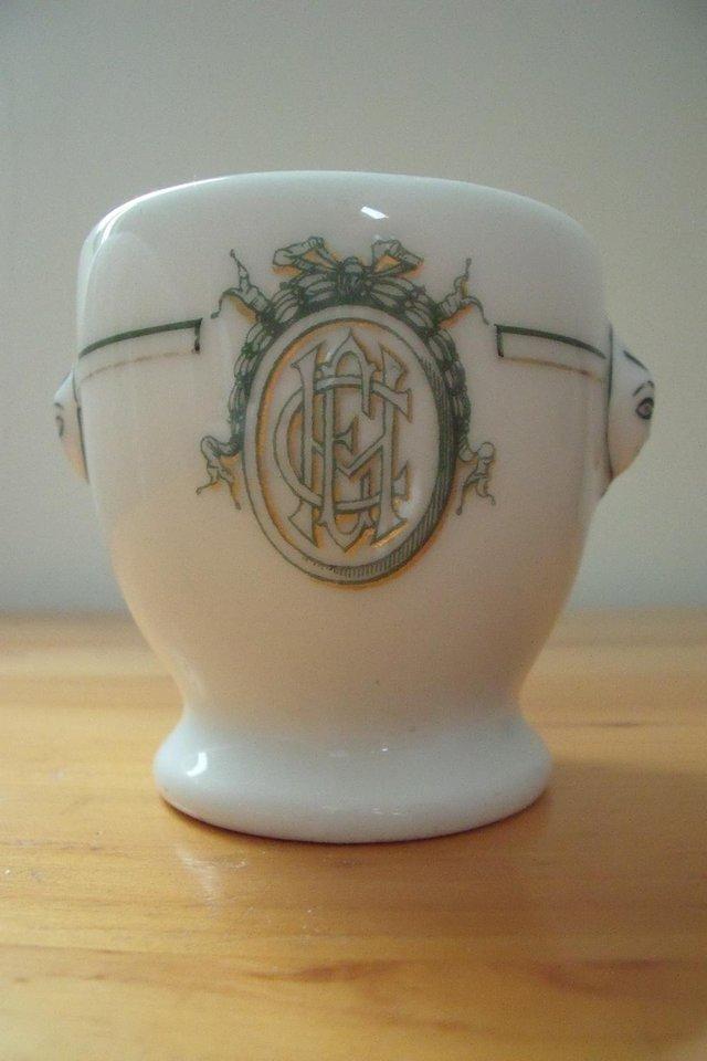 Preview of the first image of A Hache & Cie (Paris) white ceramic egg-cup shape pot..