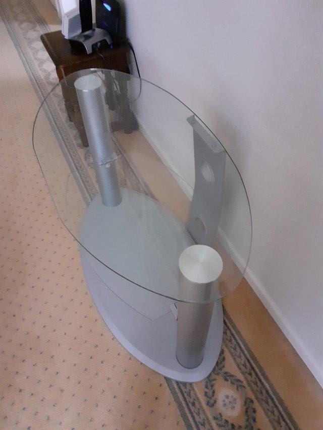 Preview of the first image of GLASS OVAL SHAPED TV STAND With a glassshelf.