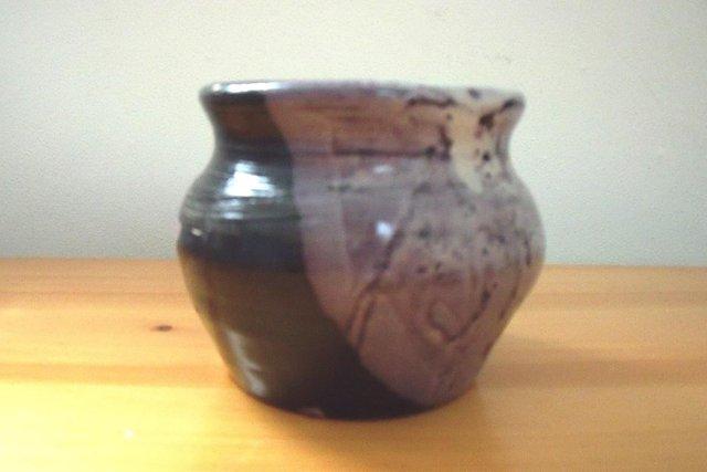 Preview of the first image of Heavy hand-thrown pot with glaze in shades of purple..