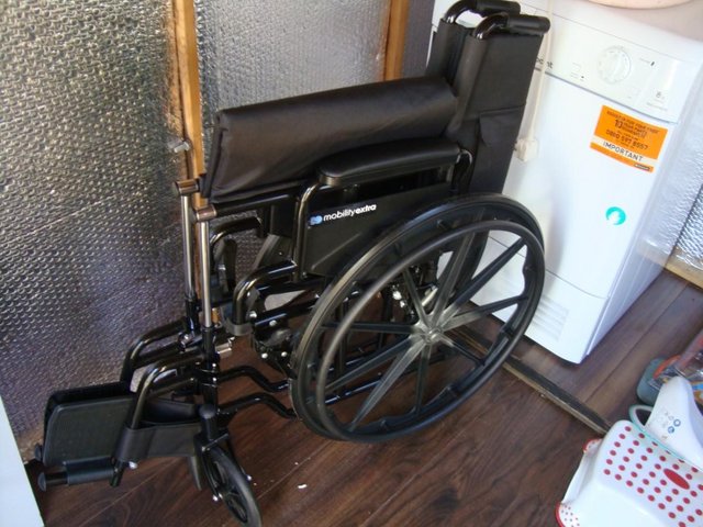 Preview of the first image of Wheelchair unused bargain for someone, 18" wide seat. Solid.