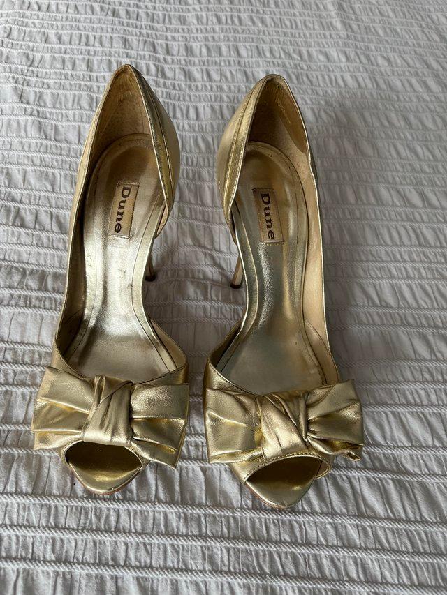 Preview of the first image of Dune stilettos size 6 gold coloured.