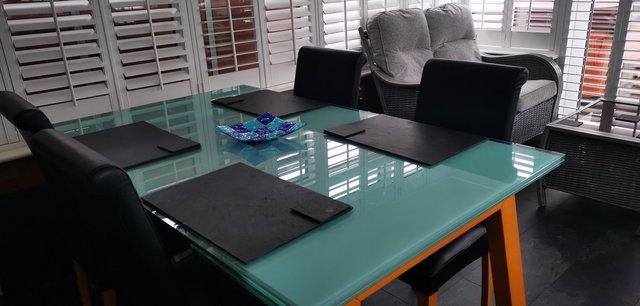 Image 1 of Calligaris blue tempered glass dining table.