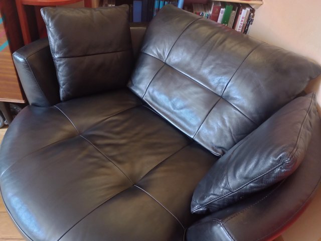 Preview of the first image of DFS black leather 2 seater swivel cuddler great condition.