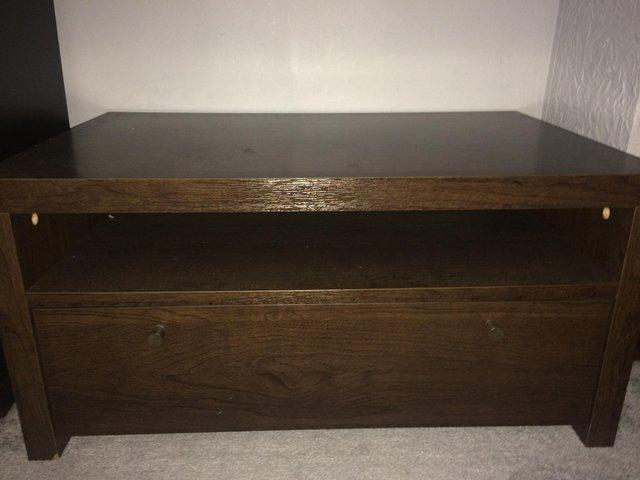 Preview of the first image of Brown wood tv stand with one large drawer.