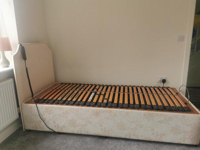 Preview of the first image of Adjustable Electric bed with headboard.