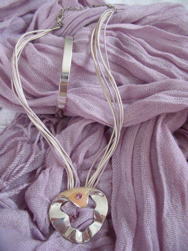 Preview of the first image of Silver coloured metal bangle-pendant/amethyst colour stones.