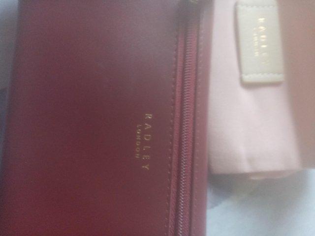 Preview of the first image of Radley large burgandy purse for sale.