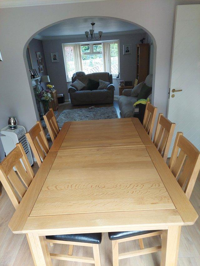 Preview of the first image of OAK FURNITURE LAND EXTENDING TABLE AND 6 CHAIRS.