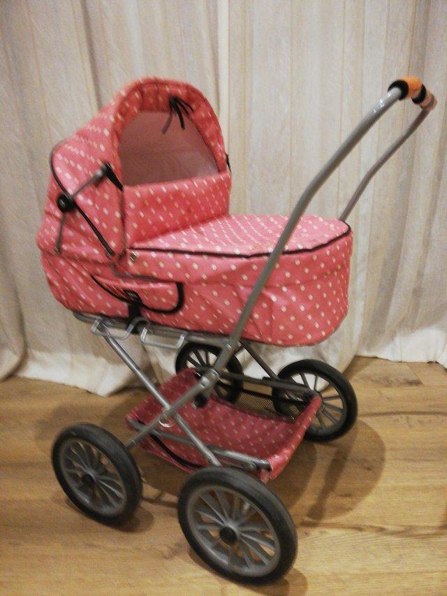 Preview of the first image of Childs toy pram, made by BRIO.