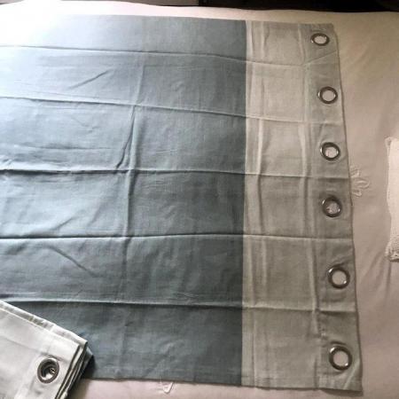 Image 3 of Unused eyelet light blue curtains. Each 56" long x 46" wide