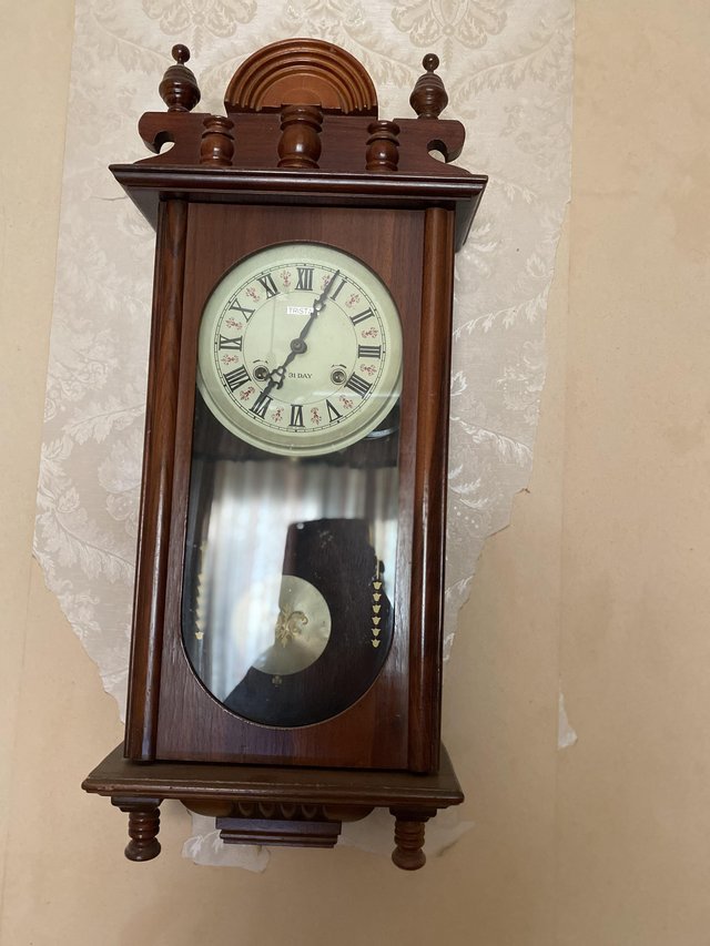 Preview of the first image of Antique Reproduction pendulum wind up clock.