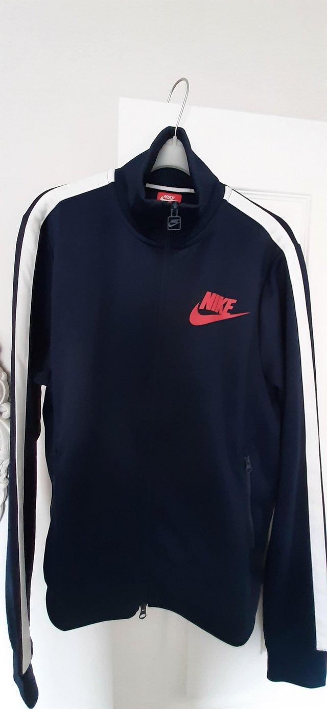 Preview of the first image of Nike zip up tracksuit top.