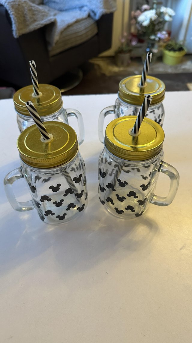 Preview of the first image of Disney Mickey head mason jar with lid and straw, set of 4.