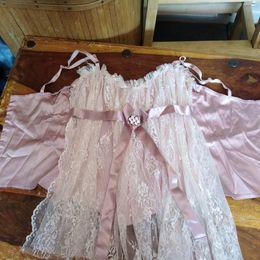 Preview of the first image of Small pink lace and satin corset top with diamante clasp..