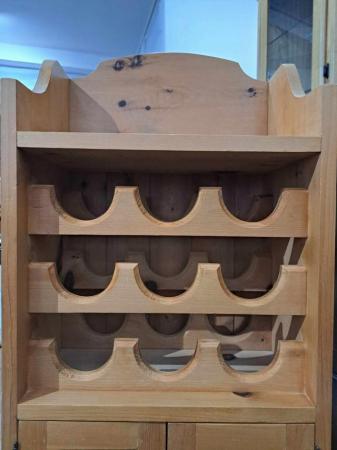 Image 1 of Pine wine rack with cupboard.