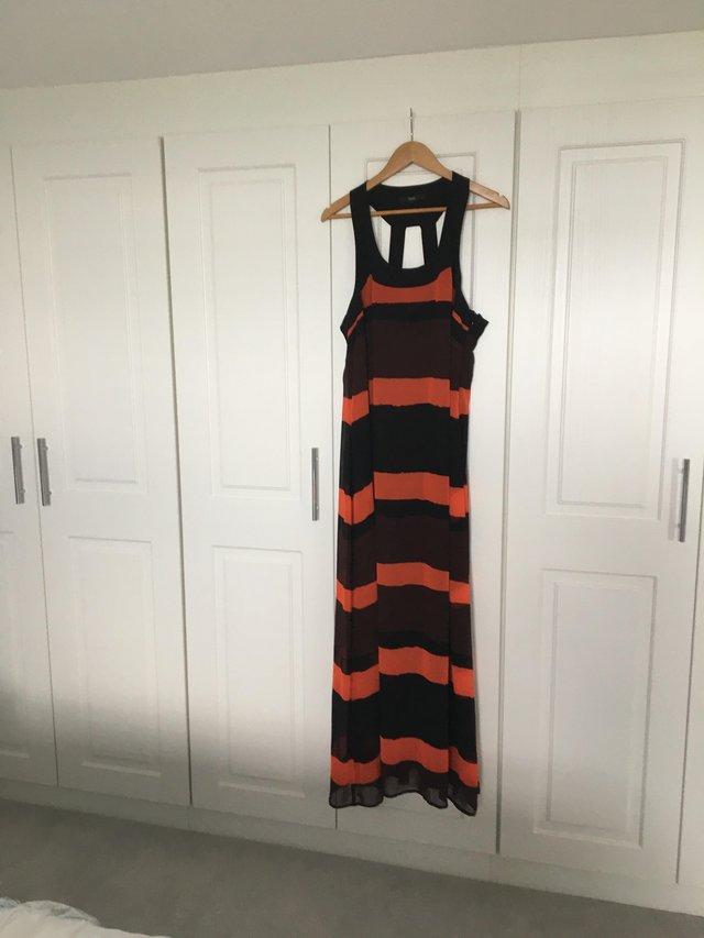 Preview of the first image of Lovely black,brown and orange striped dress.