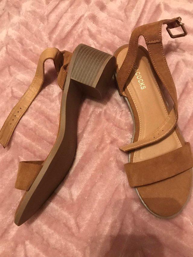 Preview of the first image of Tan sandals  in size 8 never worn.