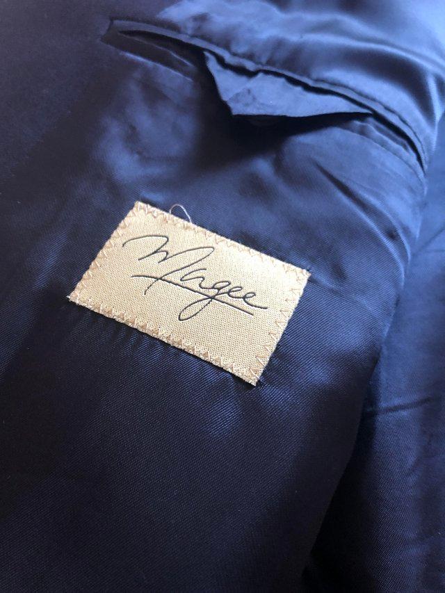 Preview of the first image of Navy blue blazer, like new measures 48” across the chest.